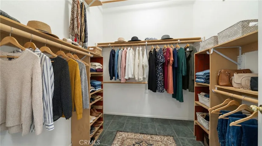 Walk-In Closet With Built-In Shelving And Organized Storage - Digitally Staged