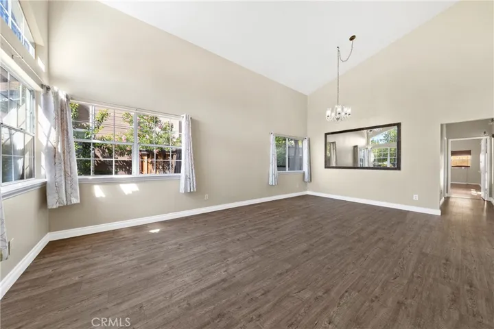 Open Living Space With Abundant Natural Light And Modern Flooring Throughout