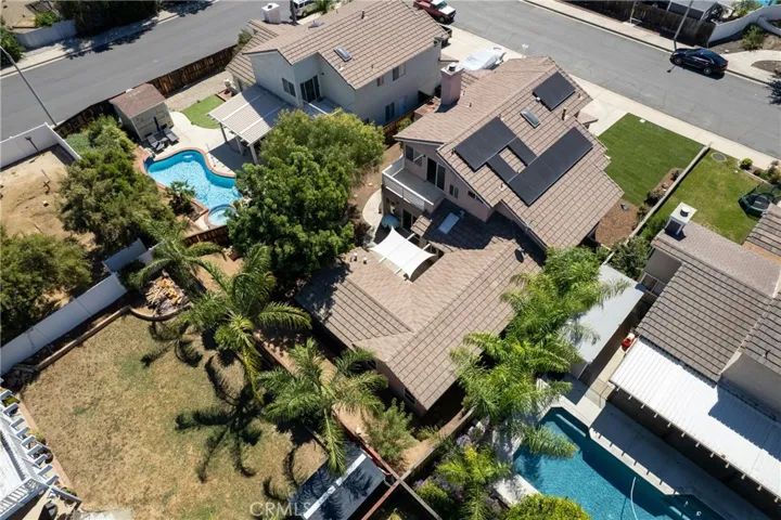 Aerial View Highlighting Backyard, Landscaping, And Nearby Homes