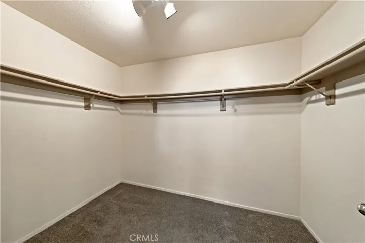 Spacious Walk-In Closet With Wraparound Hanging Space
