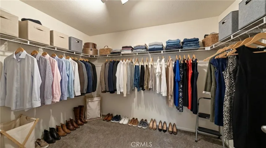 Spacious Walk-In Closet With Wraparound Hanging Space - Digitally Staged