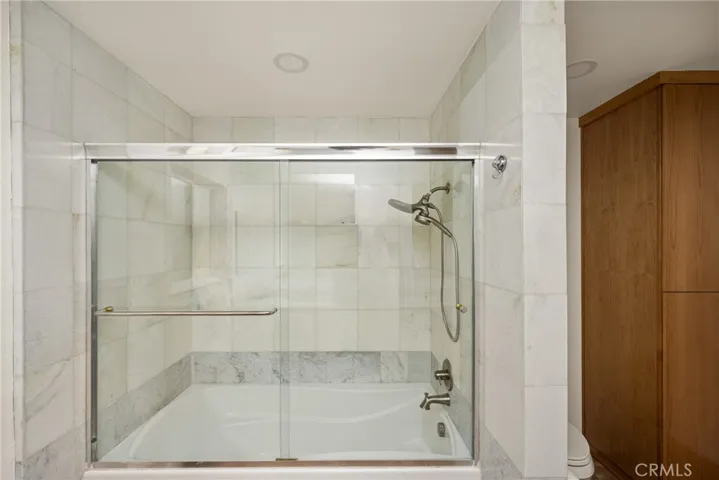 The primary bath has a tub, shower and easy-care shower glass doors added.