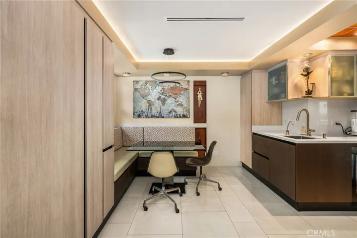 Yes, there is a hidden Sub-Zero refrigerator on the left, and a convenient prep sink with instant hot and cold water to the coffee bar, with a built-in wine cooler below it.