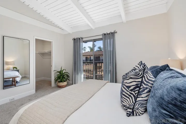Brand new carpet, vaulted wood beamed ceiling, freshly painted, sliding glass door to balcony, walk-in closet and additional traditional closet.