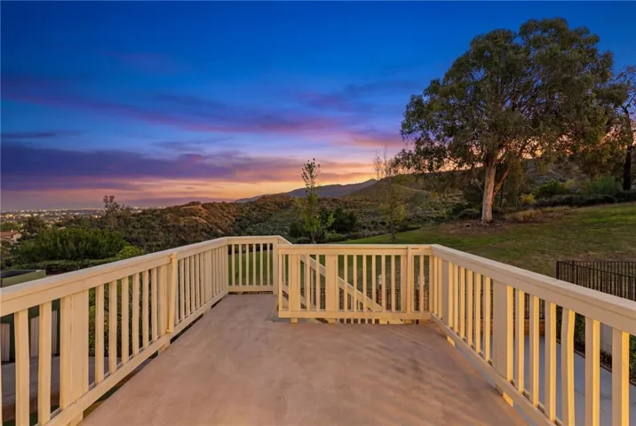 Elevated deck captures panoramic hillside and sunset views, offering a peaceful setting for morning coffee or evening unwinding.
