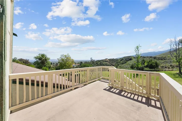 Upper deck offers an elevated outdoor retreat with sweeping hillside and neighborhood views.