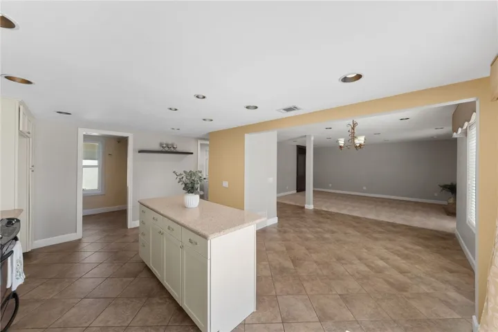 Kitchen opens seamlessly to the main living areas, creating a versatile layout with defined spaces for dining and gathering.