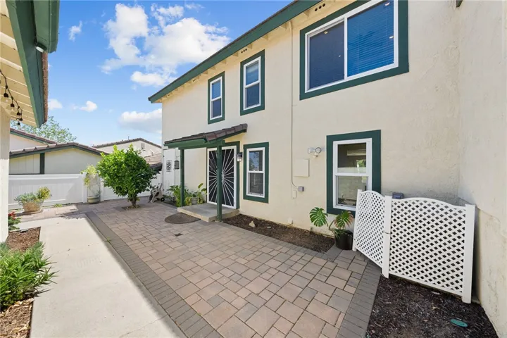 Gated courtyard offers a low-maintenance outdoor space with room for container gardening and seating.