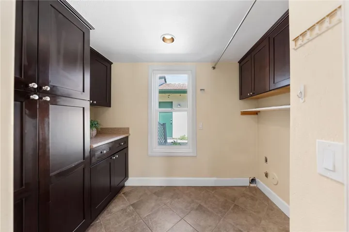 Dedicated laundry room offers built-in cabinetry, counter space, and storage to help keep household tasks organized.