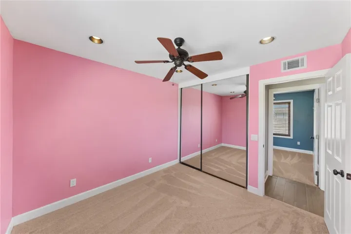 Another secondary bedroom provides a comfortable layout with natural light and easy access to the hall bath.