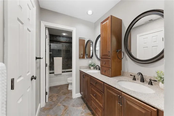 Spacious primary bath features a dual-sink vanity with ample cabinetry, generous counter space, and direct access to the tub and shower​​‌​​​​‌​​‌‌​​‌​​​‌‌​​​‌​​‌‌​​‌‌​​‌‌​​​​ area.