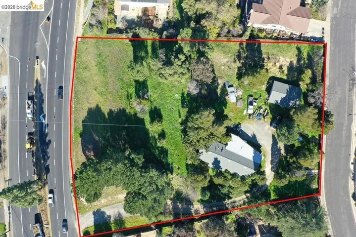 Aerial view of property and surrounding area featuring property parcel outlined