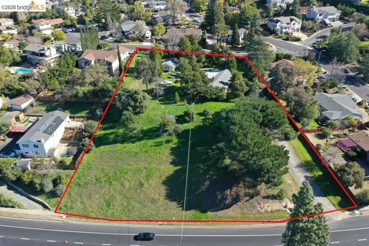 Aerial view of residential area with property parcel outlined