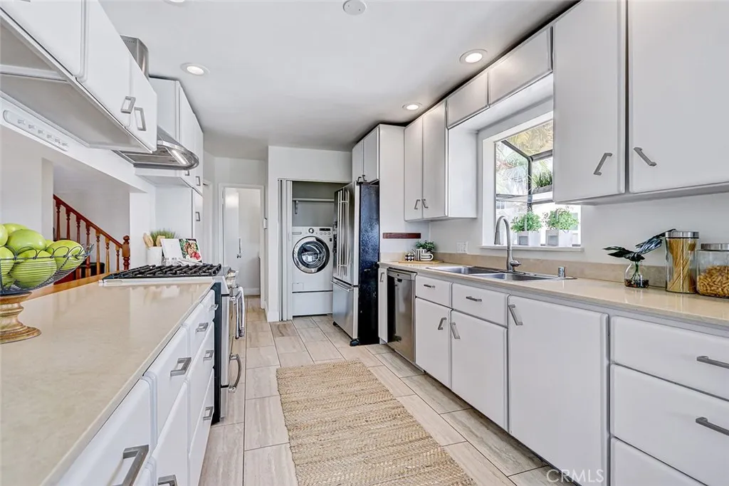 Second view of kitchen showing laundry closet