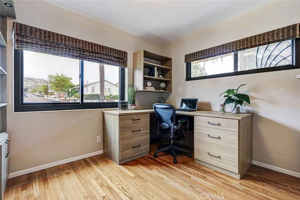 4th bedroom located on the first floor being used as an office.  It features a "Murphy Bed" in the custom cabinetry of the room