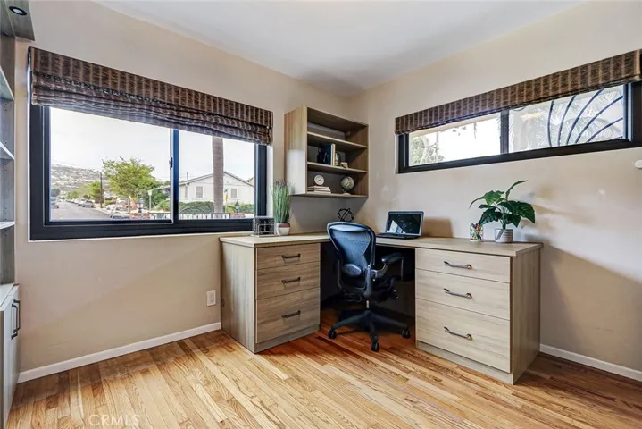 4th bedroom located on the first floor being used as an office.  It features a "Murphy Bed" in the custom cabinetry of the room
