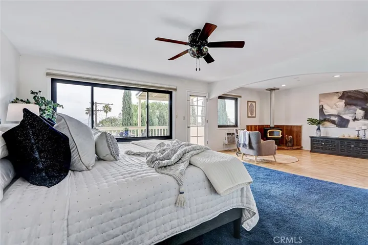 Main bedroom on second floor has balcony and seating area