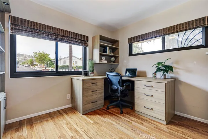 4th bedroom located on the first floor being used as an office.  It features a "Murphy Bed" in the custom cabinetry of the room