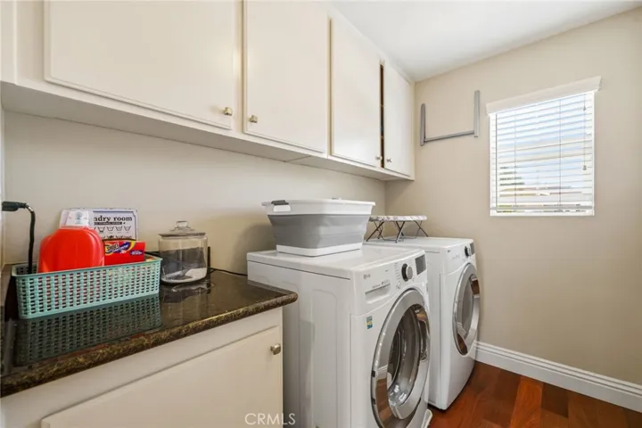 Dedicated upstairs laundry room with folding counter and gas hookups.