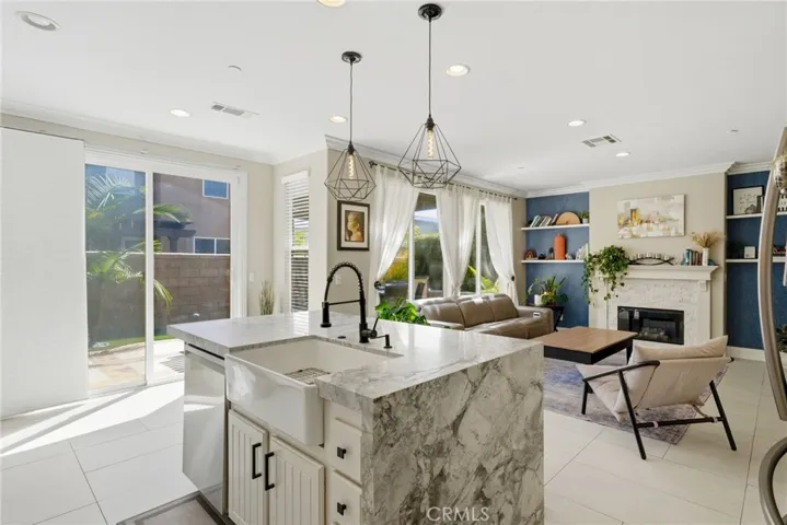 White cabinetry with matte black finishes and stainless steel appliances.
