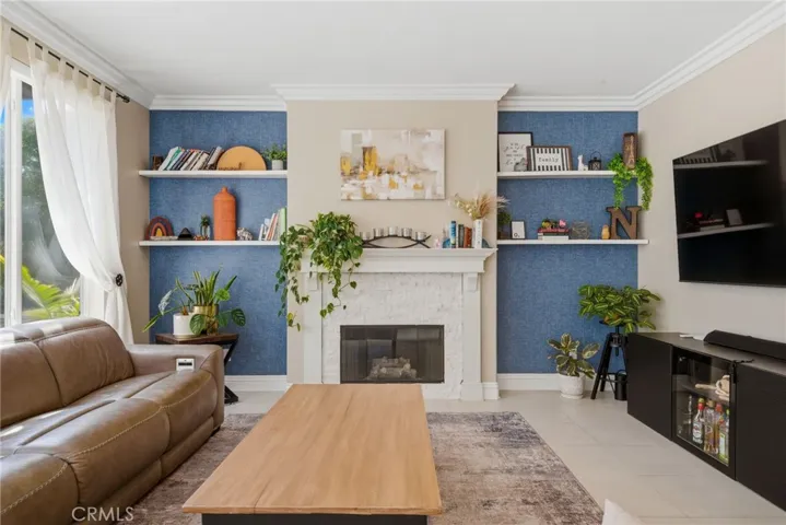 Secondary living area just off the kitchen featuring a stacked stone fireplace.