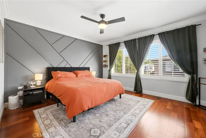 Spacious primary suite with plantation shutters and abundant natural light.