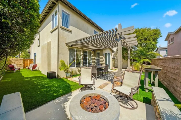 Built-in gas BBQ, firepit, and spacious hardscape for gatherings.