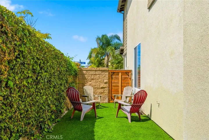 Artificial turf and low-maintenance landscaping complete the space.