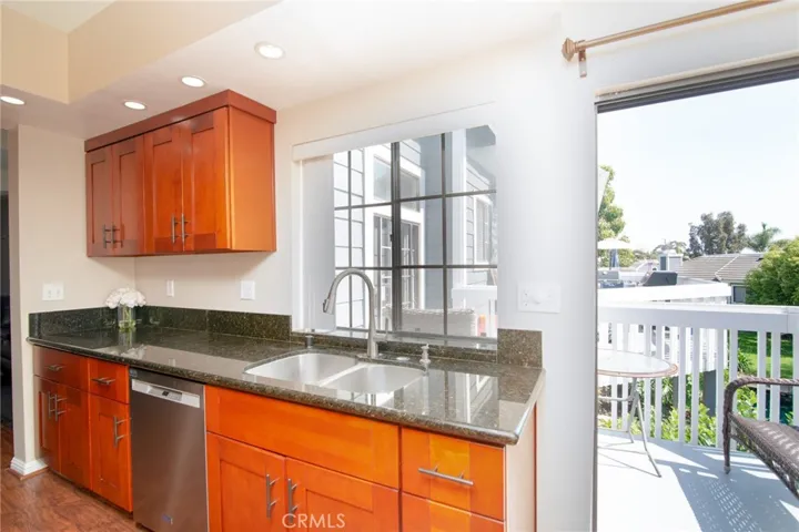 Stainless steel sink and dishwasher also enhance this lovely kitchen.