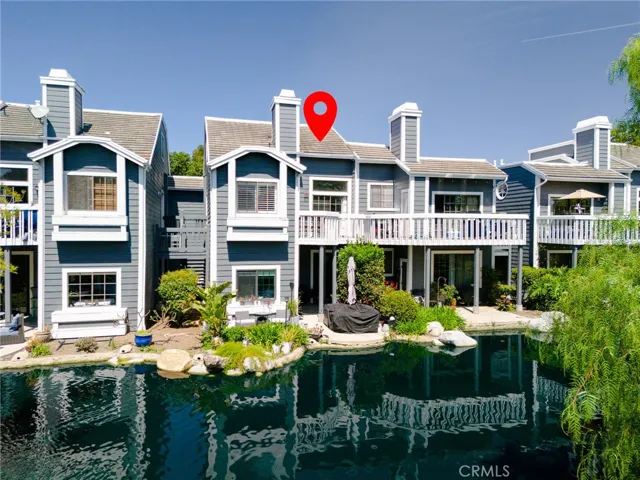 A view of the back of the home, you can see the lovely pond that is enjoyed from the balcony.