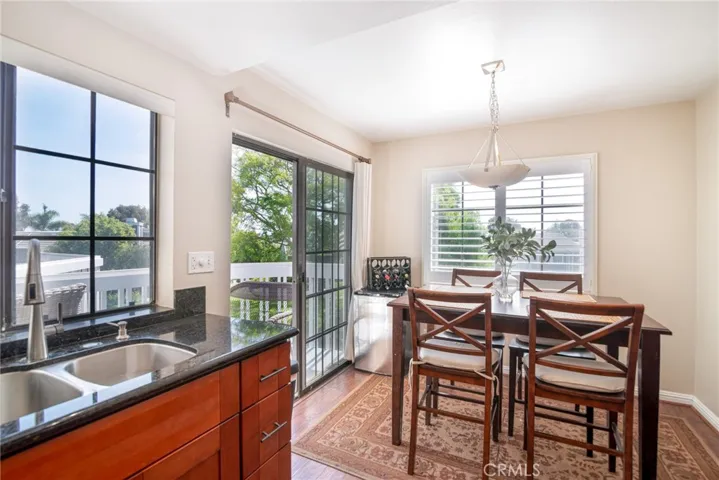 The kitchen boasts 2 large windows and a slider that all look out to mature trees and a running pond.
