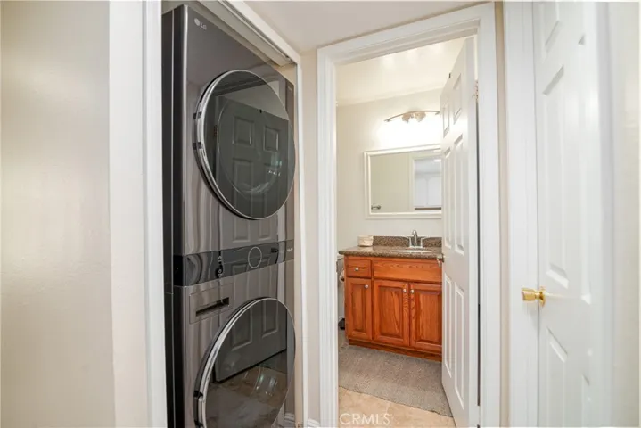 The hallway features brand new stackable washer and gas dryer.