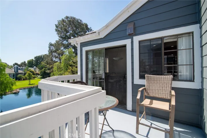 The wrap-around balcony features 2 sliders - 1 in the kitchen and 1 in the living room. Plenty of room for a table and chairs to enjoy the lovely water feature and mature trees.