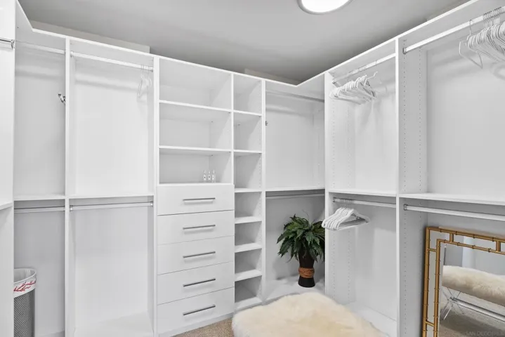 Very large and luxuriously appointed walk in closet.