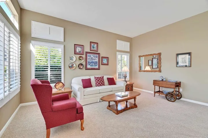 Carpeted living room featuring baseboards