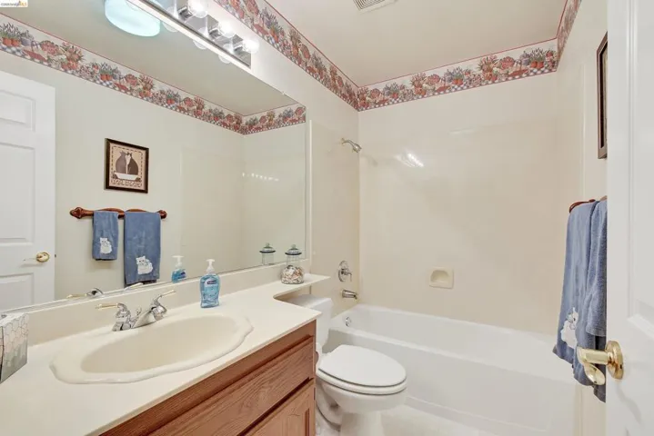 Full bath featuring vanity and shower / bathtub combination
