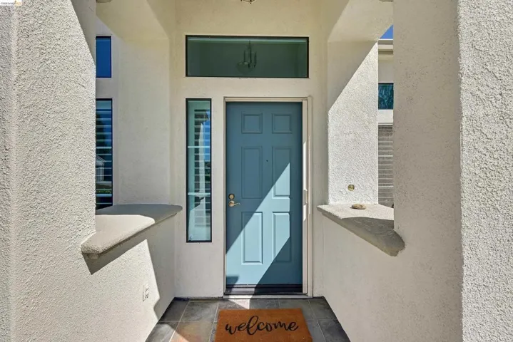 Entrance to property featuring stucco siding