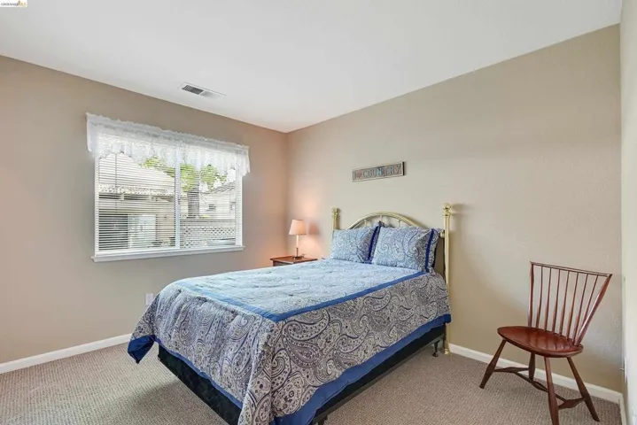 Carpeted bedroom with baseboards