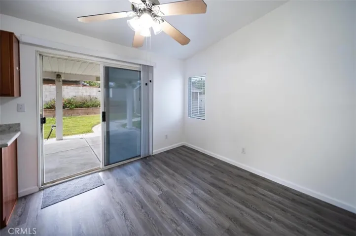 Dining area off kitchen with fan and sliding door to backyard