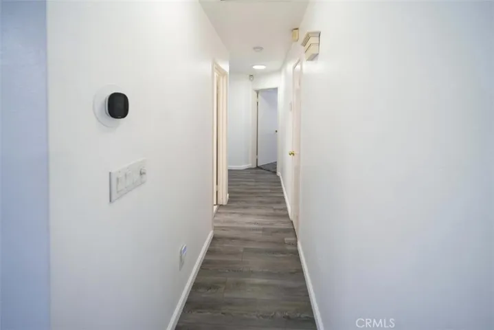 Hall with LVP floors, whole house fan