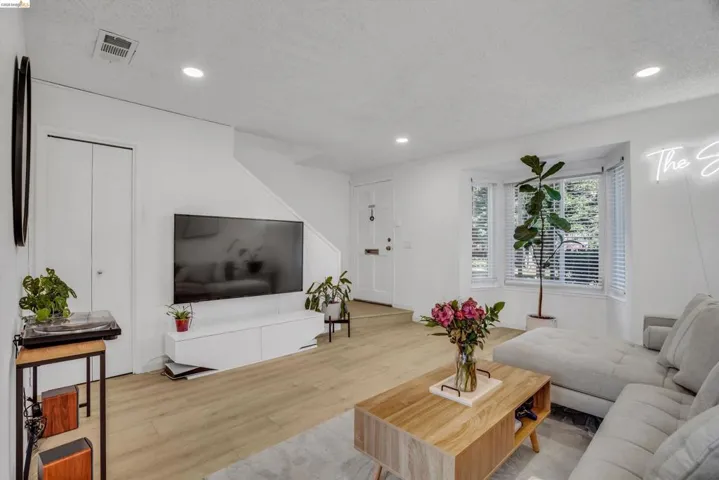 Living room featuring wood finished floors, recessed lighting, and a textured ceiling