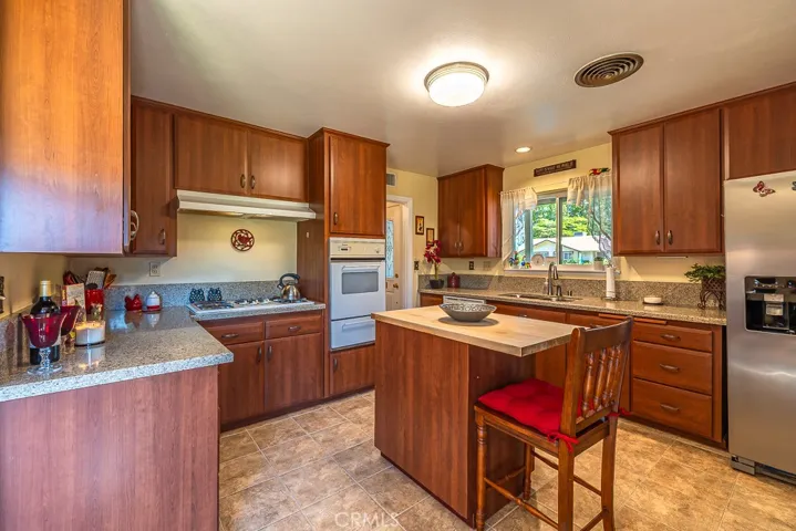 Great Chef's Kitchen with small island, double sink with garden window looking out to the front yard