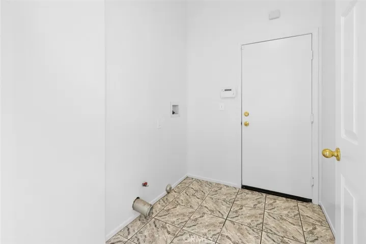 Indoor laundry room offers space for added storage.