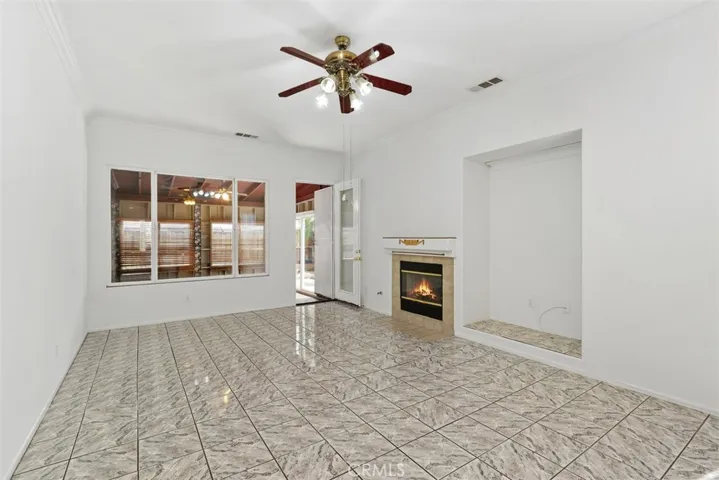 Family room has a wood-burning fireplace and niche to use as is or to customize w/built-ins.