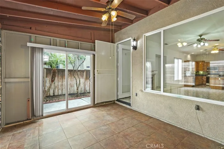 Enclosed patio w/sliding glass door to side yard.