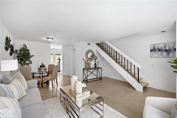 Living room with formal dining area and tile flooring