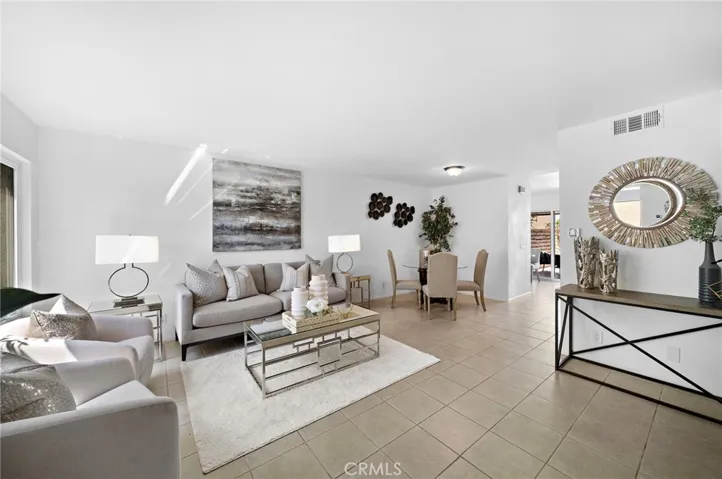Spacious living room with formal dining area, fireplace, and tile flooring