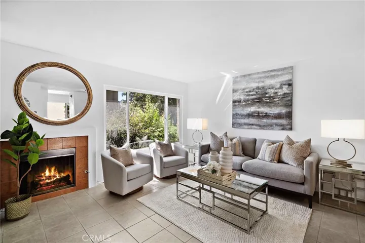 Living room with dual pane windows, fireplace, and title flooring
