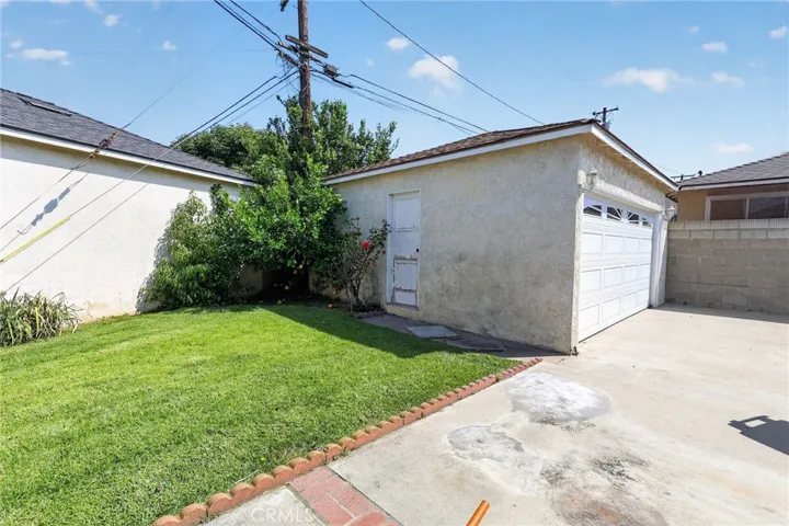 Backyard and 2 car garage with new garage door