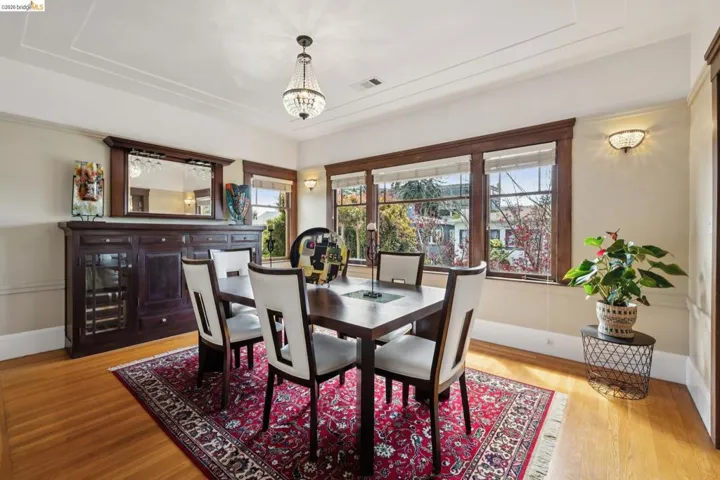 Dining room featuring light wood-style flooring, healthy amount of natural light, and suspended lighting